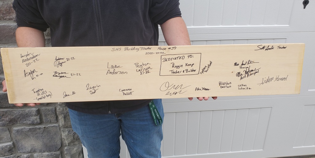 Student holds a board full of signatures 