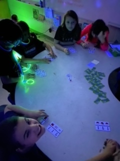 students review for a test under black light