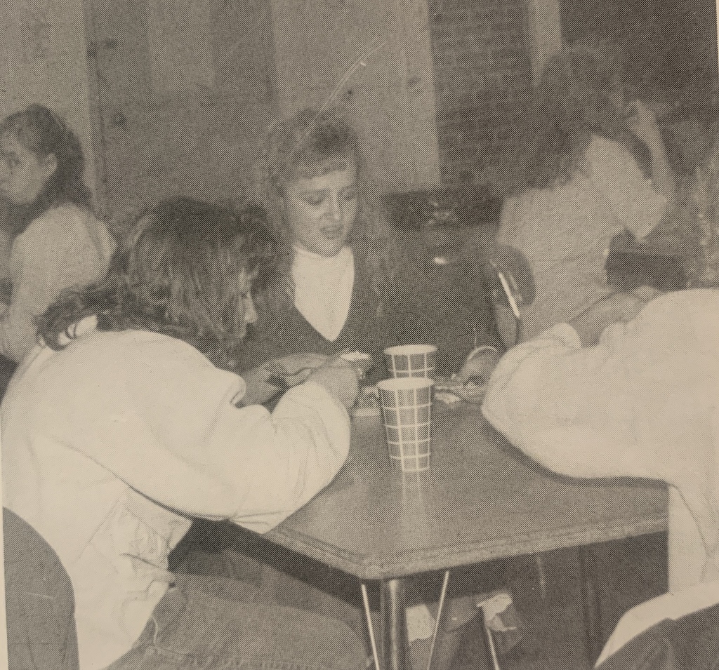 students sitting at a table enjoying a meal