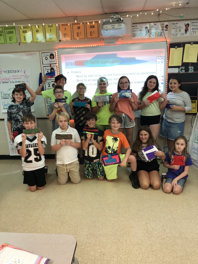 students hold up their duct tape wallets