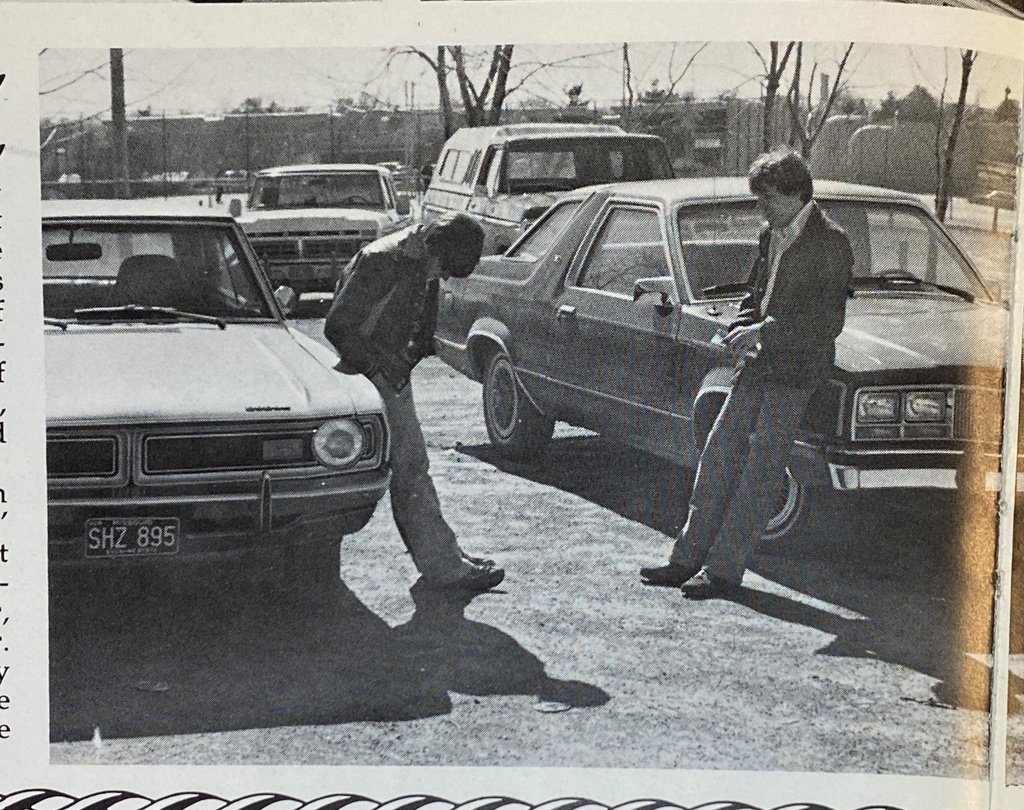two boys lean against their vehicles in 1980