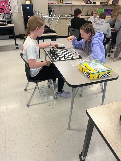 two students play chess 