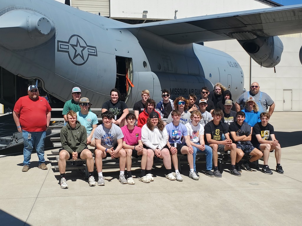 Group of high schools students pose for a picture in front of a US Aircraft